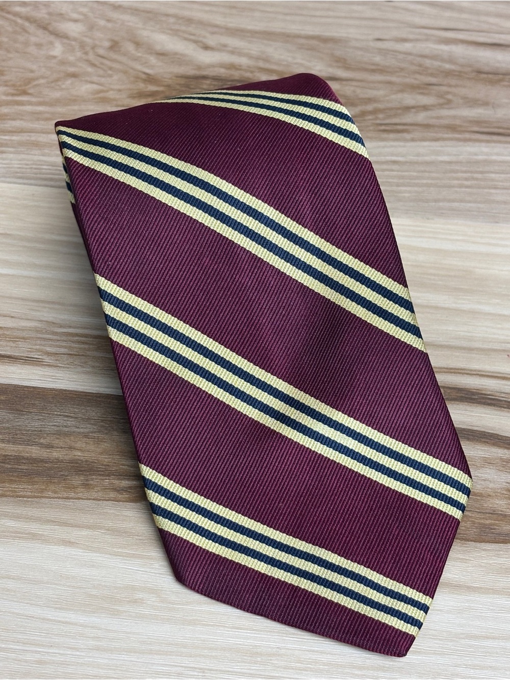 Brooks Brothers Burgundy with gold and black stripes Repp tie.